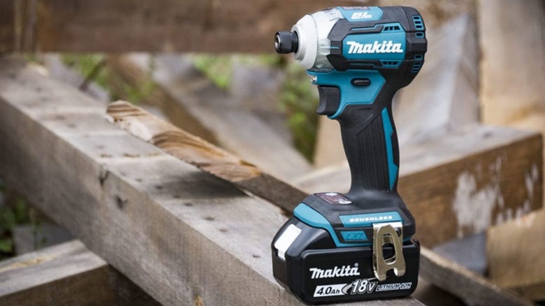 Impact driver sitting on a plank of wood