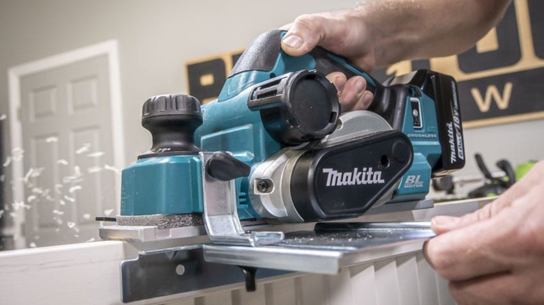 Person using a planer on wood