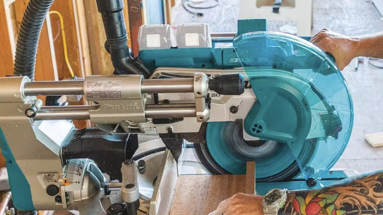 Person using a miter saw on a table