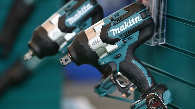 Makita drills hanging on side of toolbox