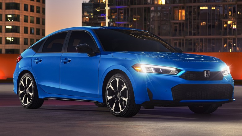 2025 Honda Civic Hatchback Sport Touring Hybrid In Blue During Evening In The City