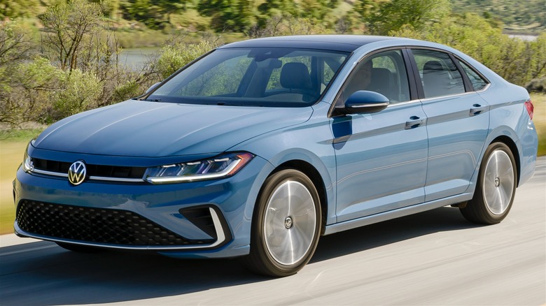 2025 Volkswagen Jetta In Blue Driving Along A Scenic Road