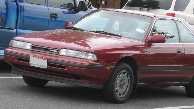 Dark red Mazda MX-6  in parking lot