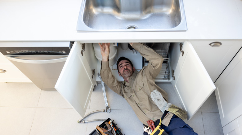 Man Fixing A Sink