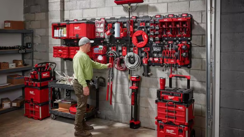 Man in front of a wall of Milwaukee Packout products