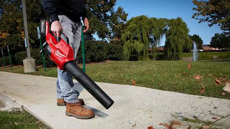 person using Milwaukee leaf blower