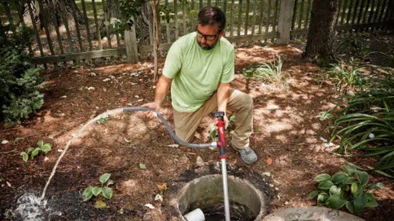 Man pumping drain