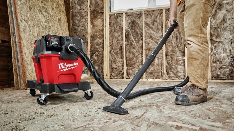 person using milwaukee shop vac