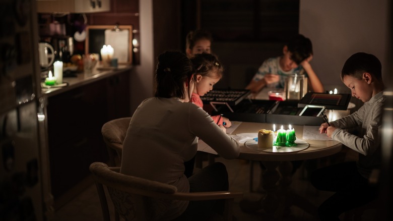 power outage family at candlelit table