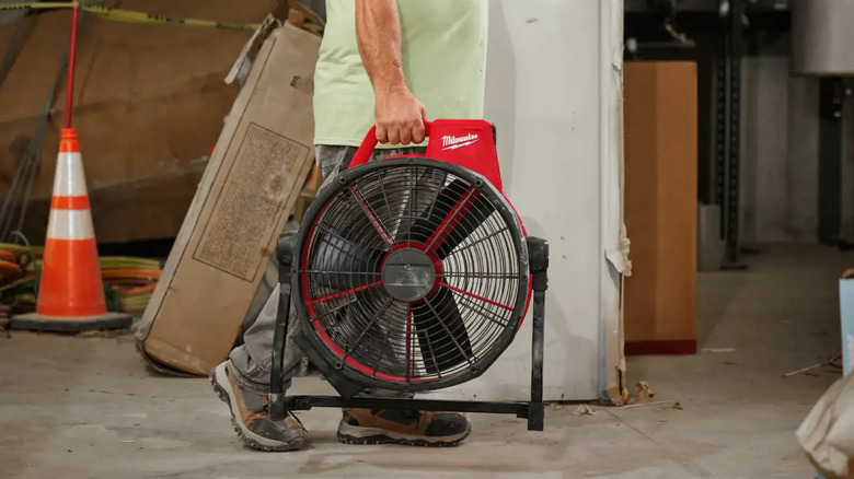 Person carrying Milwaukee fan