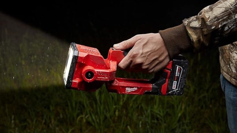 Person holding Milwaukee search light