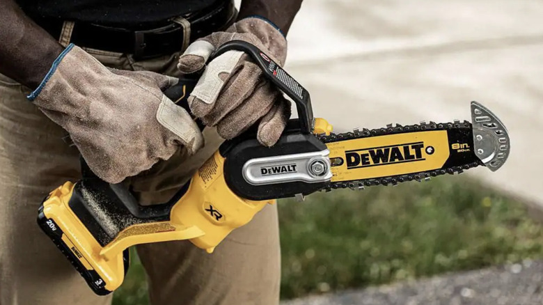 Person holding Dewalt chainsaw