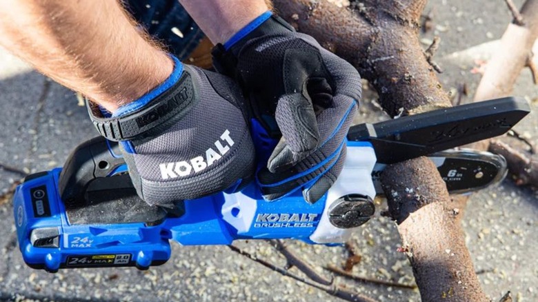 Close up of Kobalt chainsaw being used