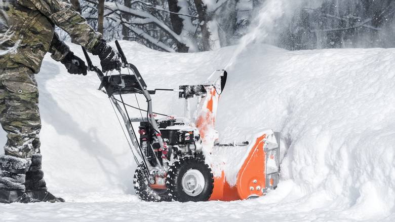 Person pushing snow blower