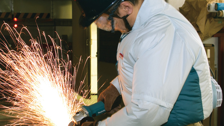 person in white jacket welding