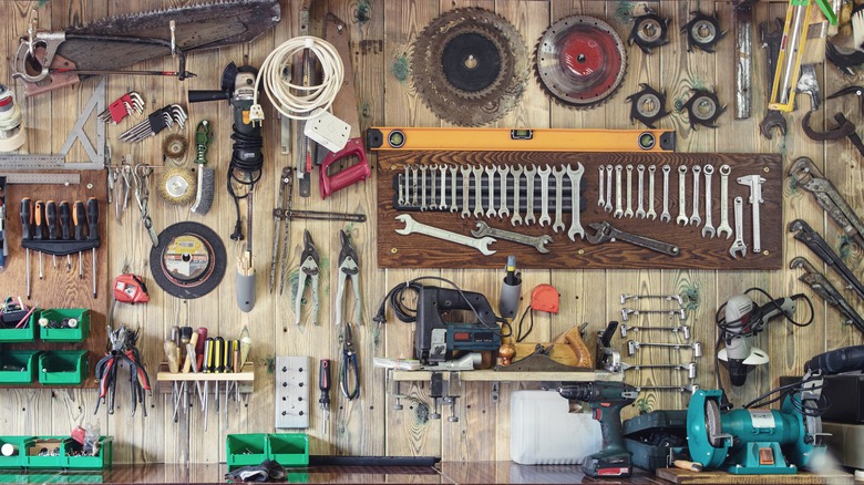 assortment of tools on wall and table