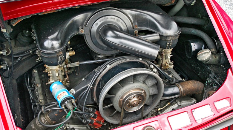 a Porsche air-cooled-flat-6 engine in a red Porsche