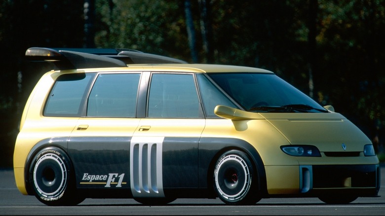 Yellow and black Renault Espace 1 van parked with trees in background