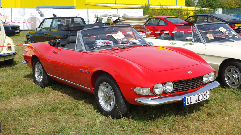 red 1969 Fiat Dino Spider parked on grass