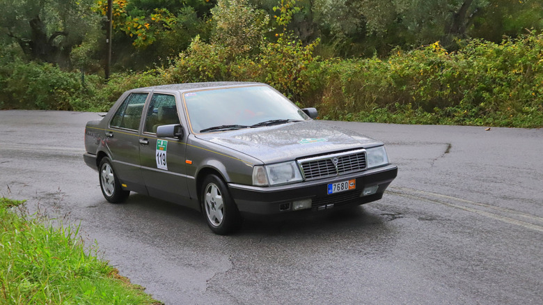 Lancia Thema driving on rural road