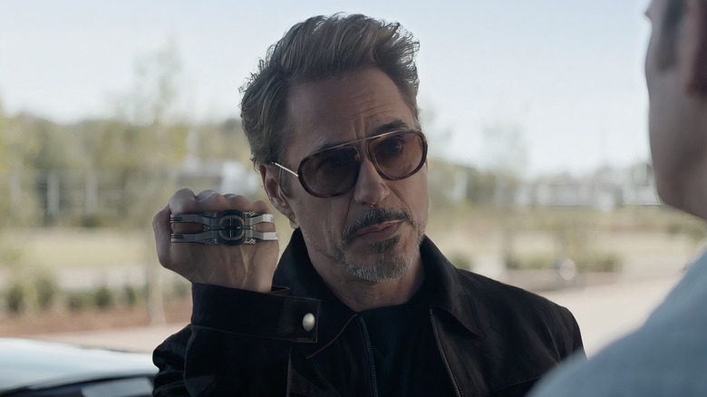 Tony Stark holding Time-Space GPS