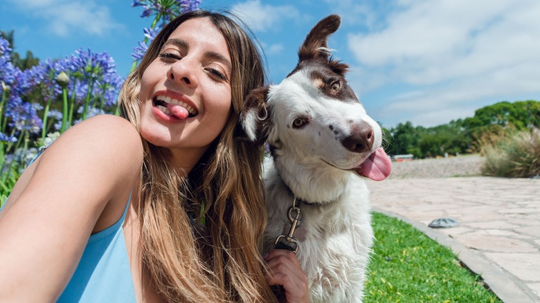 woman taking selfie with her dog