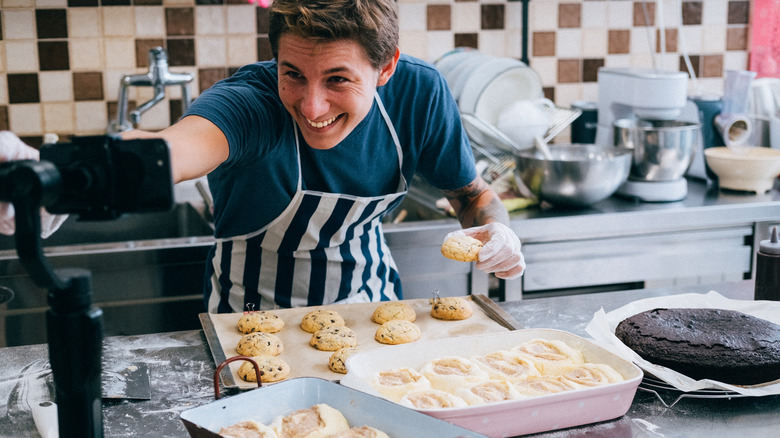 a man taking a video of himself making bread