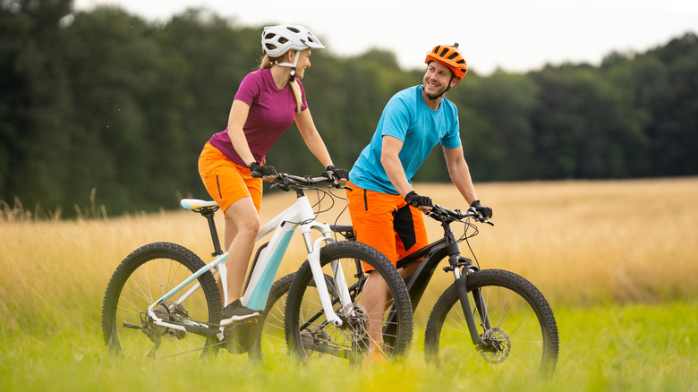 Two people riding electric bikes 