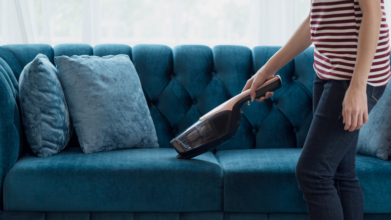 woman using handheld vacuum cleaner