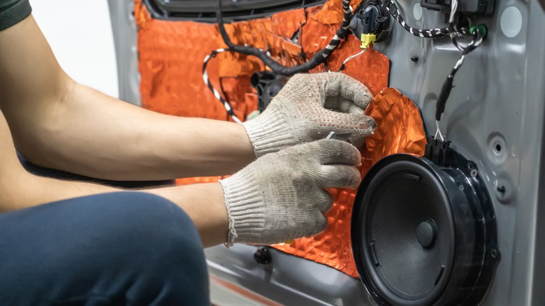 person installing car speakers