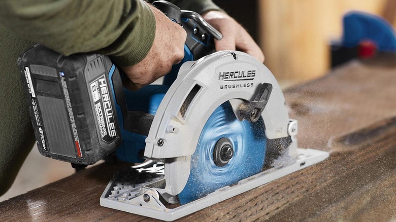 Person cutting wood with a circular saw