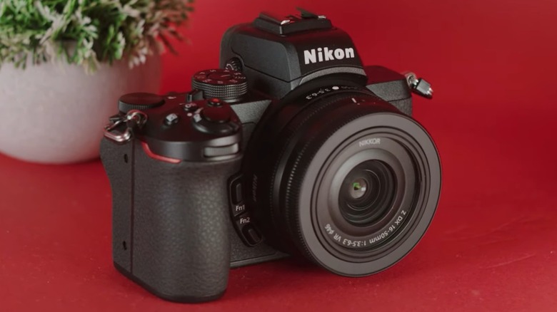 A Nikon Z 50 camera on a red table.