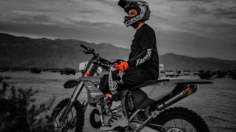 orange gloves in black and white dirt bike and rider photo