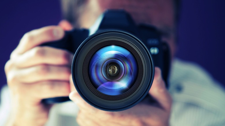 a photographer taking a picture of their camera on a mirror