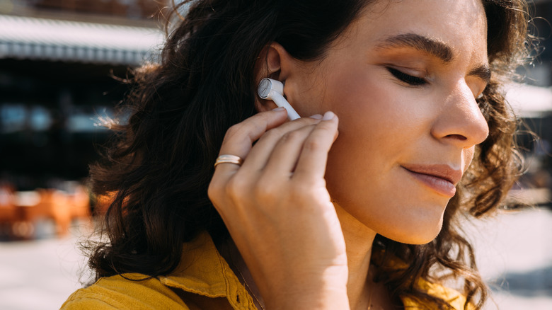 Woman using ear buds