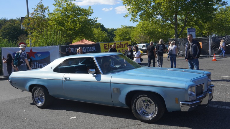 Blue Oldsmobile Delta 88 parked