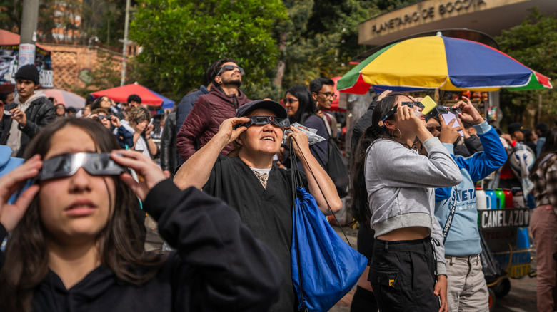 crowd looking eclipse solar viewer glasses