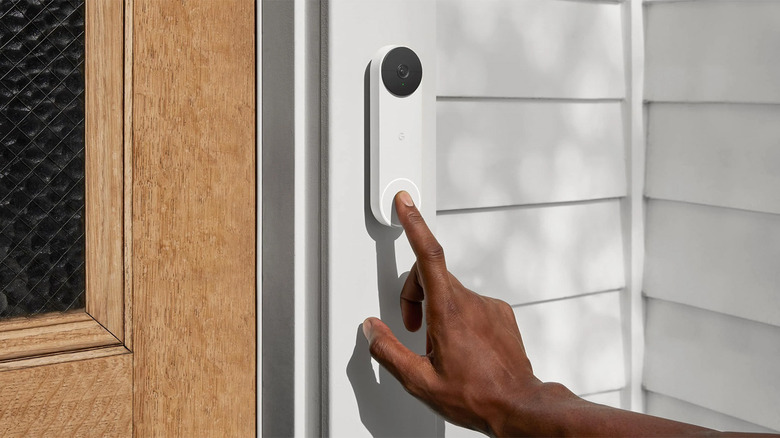 Person pressing Nest Doorbell