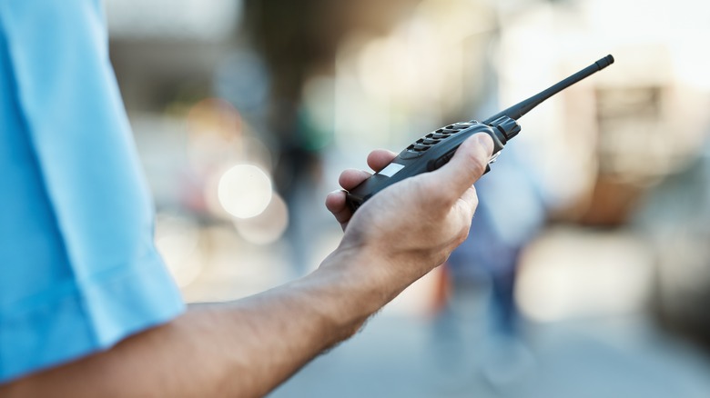 hand holding walkie talkie