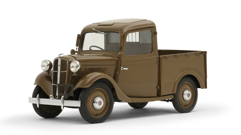 Brown 1938 Nissan 17T pickup on white background