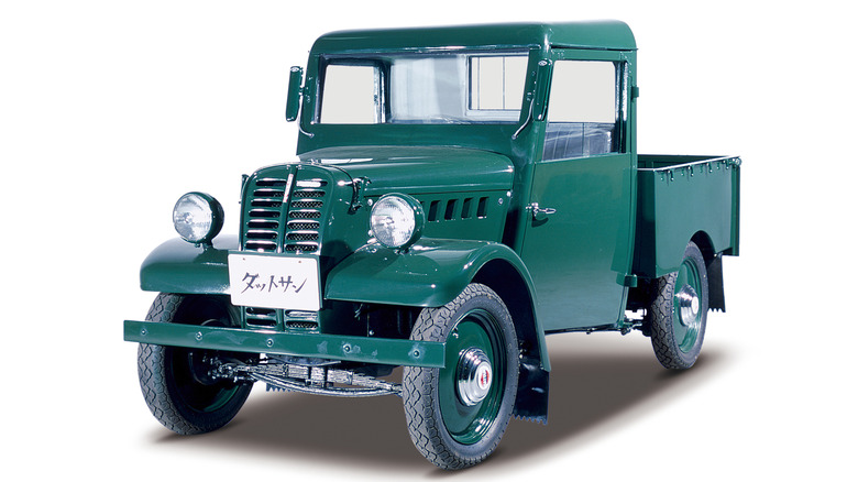 Green 1948 Nissan 2225 pickup truck against white background