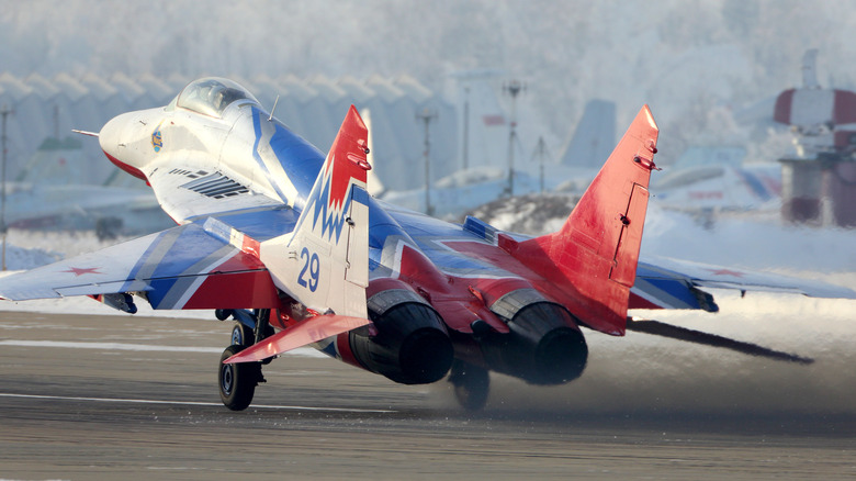 Red White and Blue MIG-29 taking off from runway