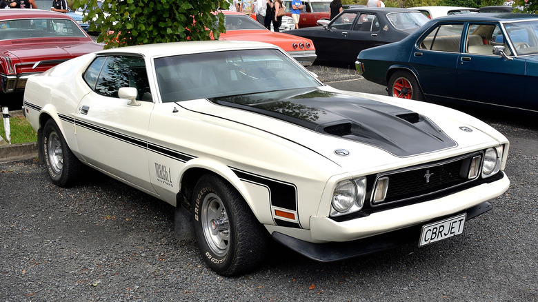 White 1973 Ford Mustang with black trim and CBR JET license plate in parking lot