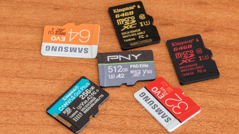 several micro SD cards from different brands on a wood surface