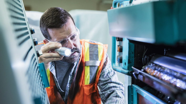 Man looking inside printer