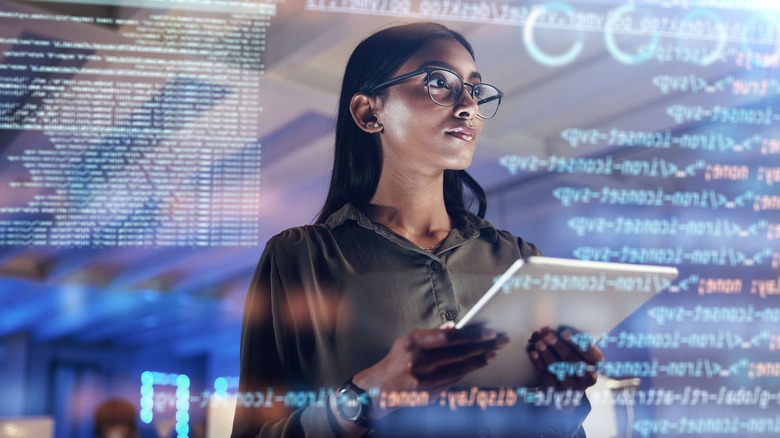 woman on tablet thinking of data analytics