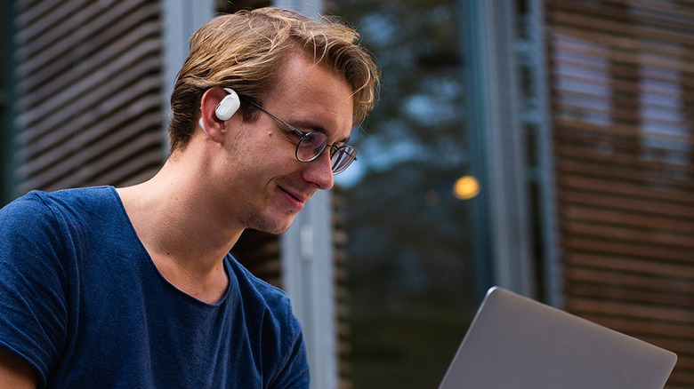 man wearing oladance ows2 earphones