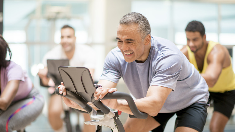 group at gym on exercise bikes