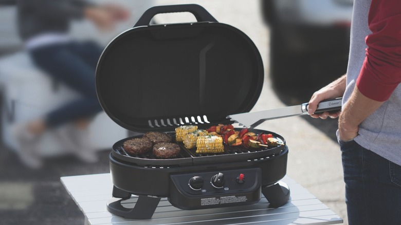 Food grilling on a Coleman RoadTrip 225 Portable Tabletop grill