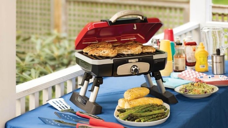 Chicken cooking on Red Cuisinart Petit Gourmet Portable Tabletop Gas Grill